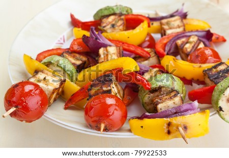 plate with halloumi and vegetables kebabs on a table
