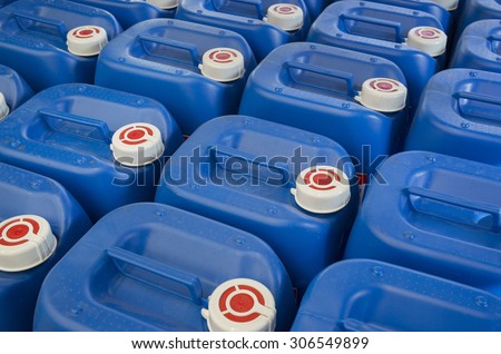 Blue plastic barrels containing chemicals in storage