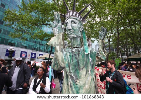 NEW YORK CITY - MAY 1 : Occupy Wall Street members wrangle their own Statue of Liberty in Bryant Park before marching in honor of International Workers\' Day  on May 1 2012 in New York City
