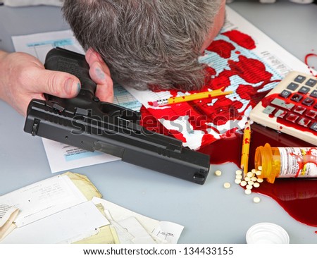 Tax Relief Gets Radical/Man\'s head laying against desktop covered with blood, IRS forms, a calculator, spilled pills & vial, & handgun on white desktop