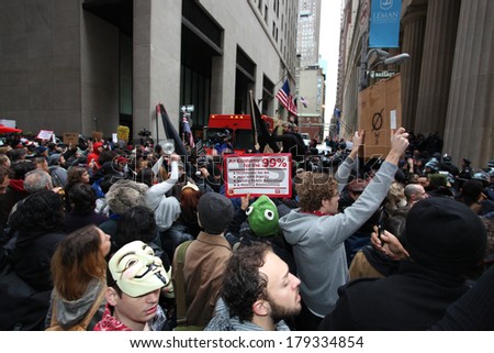 NEW YORK CITY - NOVEMBER 17 2011: Occupy Wall Street, a popular movement opposed to malfeasance on Wall Street, protested expulsion from Zuccotti Park with marches all over NYC. Crowd on Wall Street
