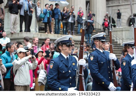 NEW YORK CITY - MAY 22 2014: The United States Coast Guard Silent Drill Team performs rifle slinging routines for the public on Wall Street before the New York Stock Exchange to mark Fleet Week