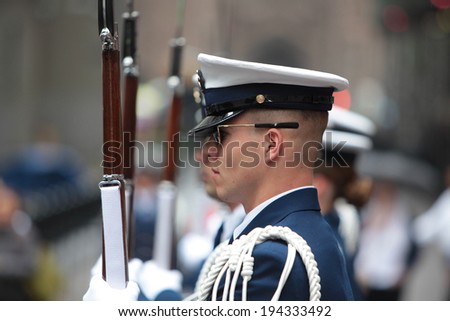 NEW YORK CITY - MAY 22, 2014: The United States Coast Guard Silent Drill Team performs rifle slinging routines for the public on Wall Street before the New York Stock Exchange to mark Fleet Week