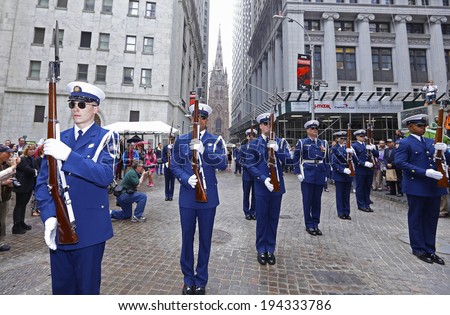 NEW YORK CITY - MAY 22 2014: Members of the United States Coast Guard Silent Drill Team perform synchronized rifle drills on Wall Street before the New York Stock Exchange to mark Fleet Week