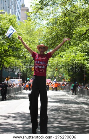 NEW YORK CITY - JUNE 1 2014: The 50th annual Israel Day Parade filled Fifth Avenue with politicians, revelers & a few protestors marking Israel\'s 66th anniversary. Stilt walking man on Fifth Avenue