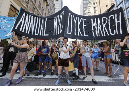 NEW YORK CITY - JUNE 28 2014: the 22nd Annual NYC Dykes March brought thousands onto Fifth Avenue & stretched from Bryant Park to Washington Square Park. Banner proceeds along Fifth Avenue