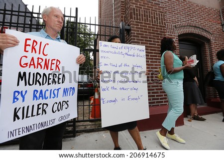NEW YORK CITY - JULY 23 2014: Funeral services for Eric Garner, the Staten Island resident who died while being taken into custody by NYPD.  Activists with signs in front of Bethel Baptist Church