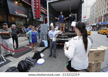 NEW YORK CITY - AUGUST 26 2014: with assistance from The Naked Cowboy, Robert Burk, Charmin bathroom tissue celebrated National Toilet Paper Day in Times Square with a dump truck of free toilet paper