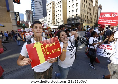 NEW YORK CITY - SEPTEMBER 4 2014: fast food workers and their supporters marched along 8th Ave calling for an increase in the minimum wage.Some attempted to block the street leading to several arrests