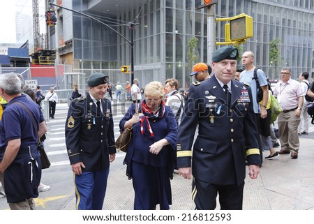 NEW YORK CITY - SEPTEMBER 11 2013: the 13th anniversary of the WTC terror attacks was observed in Lower Manhattan by first responders & relatives of attack victims. Relative with military personnel
