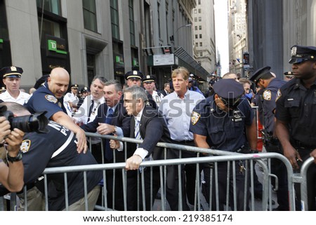 NEW YORK CITY - SEPTEMBER 22 2014: Flood Wall Street demonstrators marched from Battery Park, for a sit down at Broadway & Morris St, before preceding up to Wall Street itself where NYPD made arrests.