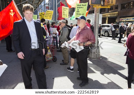NEW YORK CITY - OCTOBER 8 2014: Occupy The World Business Forum held a rally in front of Radio City Music Hall demanding a higher minimum wage & more workers\' rights during the World Business Forum