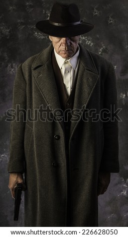 American Gunner Series/Middle age man in overcoat & fedora standing with handgun against portrait background
