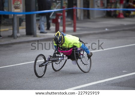 NEW YORK CITY - NOVEMBER 2 2014: the 43rd annual NYC Marathon saw more than 50,000 entrants race through all five boroughs. Wheelchair division competitor passes mile four in Brooklyn