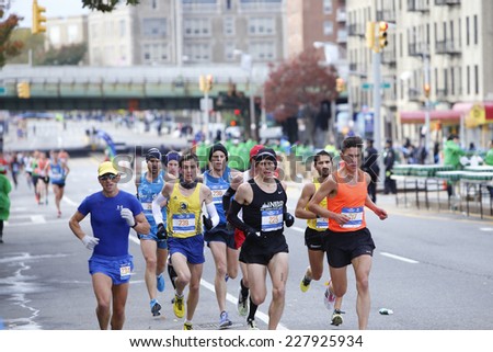 NEW YORK CITY - NOVEMBER 2 2014: the 43rd annual NYC Marathon saw more than 50,000 entrants race through all five boroughs. Pack of male elite runners pass mile four in Brooklyn