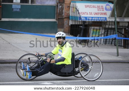 NEW YORK CITY - NOVEMBER 2 2014: the 43rd annual NYC Marathon saw more than 50,000 entrants race through all five boroughs. Wheelchair division competitor passes mile four marker in Brooklyn