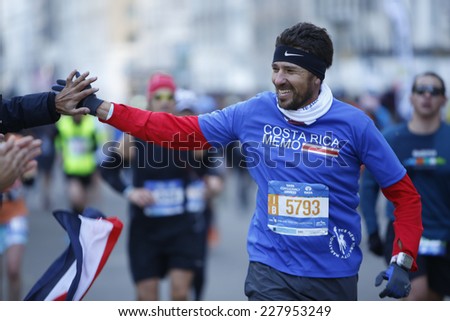 NEW YORK CITY - NOVEMBER 2 2014: the 43rd annual New York City Marathon saw more than 50,000 entrants run through all five boroughs. Male runner gets high five from spectator along 59th Street