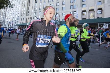 NEW YORK CITY - NOVEMBER 2 2014: the 43rd annual New York City Marathon saw more than 50,000 entrants run through all five boroughs. Array of runners approach finish line along 59th Street