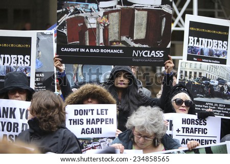 NEW YORK CITY - DECEMBER 2 2014: New Yorkers for Clean & Safe Streets held a press conference by City Hall in praise of Mayor De Blasio\'s plan to ban horse-drawn carriages.NYCLASS activists with signs