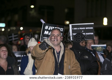 NEW YORK CITY - DECEMBER 19 2014: a planned demonstration in support of the NYPD in front of city hall prompted a larger counter-protest by activists opposing police brutality. Pro NYPD activist