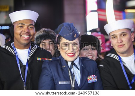 NEW YORK CITY - DECEMBER 31 2014: more than one million celebrants marked the new year in Times Square. US Navy & Air Force personnel awaiting midnight