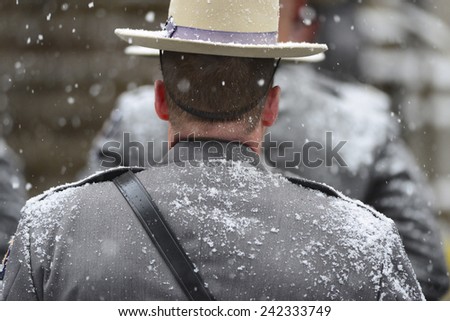 NEW YORK CITY - JANUARY 6 2015: funeral services were held for former New York governor Mario Cuomo at St. Ignatius Loyola Church on Manhattan\'s Upper East Side. NY State trooper at attention in snow