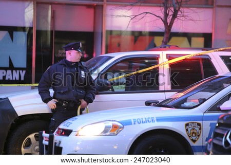 NEW YORK CITY - JANUARY 25 2015: a shooting at the Home Depot store in Chelsea left two employees dead in what is being called a murder-suicide. Officer guards vehicle possibly belonging to one victim