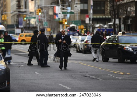 NEW YORK CITY - JANUARY 25 2015: a shooting at the Home Depot store in Chelsea left two employees dead in what is being called a murder-suicide. Investigators arrive at scene on 23rd Street