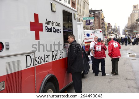 NEW YORK CITY - MARCH 27 2015: one day after a fire & explosion in Manhattan\'s East Village, 2 people remain missing as workers clear the wreckage of three destroyed brownstones.American Red Cross van