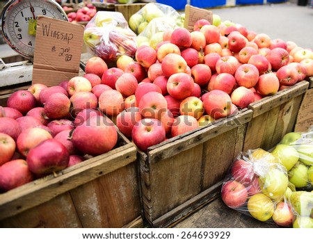 Early spring green market offerings/red delicious apples in wood bins for sale