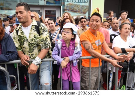 NEW YORK CITY - JULY 4 2015: Nathan\'s Famous staged its annual fourth of July hot dog eating contest in Coney Island, Brooklyn.Spectators along Surf Av prepare for the start of the women\'s competition