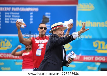 NEW YORK CITY - JULY 4 2015: Nathan\'s Famous staged their annual fourth of July hot dog eating contest in Coney Island, Brooklyn. Promoter & MC George Shea tosses tee shirts to audience