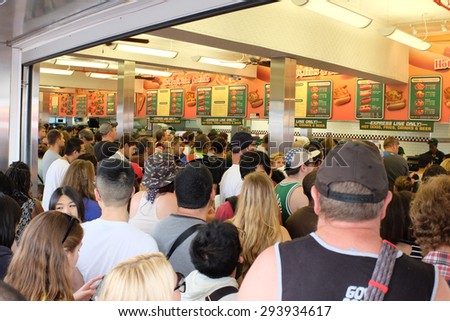NEW YORK CITY - JULY 4 2015: Nathan\'s Famous held its annual fourth of July hot dog eating contest in Coney Island, Brooklyn. People line up for hot dogs after Nathan\'s Famous hot dog eating contest