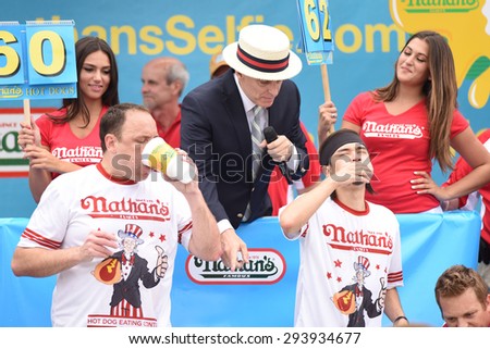 NEW YORK CITY - JULY 4 2015: Nathan\'s Famous held its annual fourth of July hot dog eating contest in Coney Island, Brooklyn. Competitors Joey Chestnut & Matt Stonie in the final moments