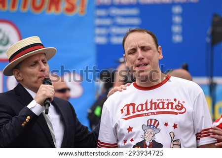 NEW YORK CITY - JULY 4 2015: Nathan\'s Famous held its annual fourth of July hot dog eating contest in Coney Island, Brooklyn. Promoter George Shea consoles runner up Joey Chestnut