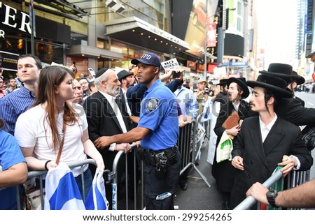 NEW YORK CITY - JULY 22 2015: thousands rallied in Times Square to oppose the President\'s proposed nuclear deal with Iran. NYPD community affairs members keep Neturei Karta apart from rally