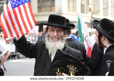 NEW YORK CITY - JULY 22 2015: thousands rallied in Times Square to oppose the President\'s proposed nuclear deal with Iran. Anti-zionist Neturei Karta members with US flag in Times Square
