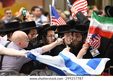 NEW YORK CITY - JULY 22 2015: thousands rallied in Times Square to oppose the President\'s proposed nuclear deal with Iran. Conflict over anti-zionist Neturei Karta\'s Palestinian flags at rally