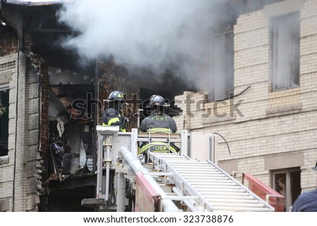 NEW YORK CITY - OCTOBER 3 2015: Fire companies, NYPD & other emergency response personnel gathered in Borough Park along with elected officials in the wake of an explosion that killed one & injured 13