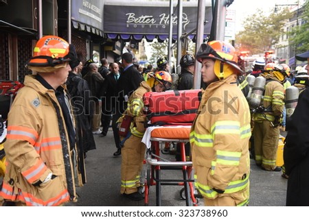 NEW YORK CITY - OCTOBER 3 2015: Fire companies, NYPD & other emergency response personnel gathered in Borough Park along with elected officials in the wake of an explosion that killed one & injured 13