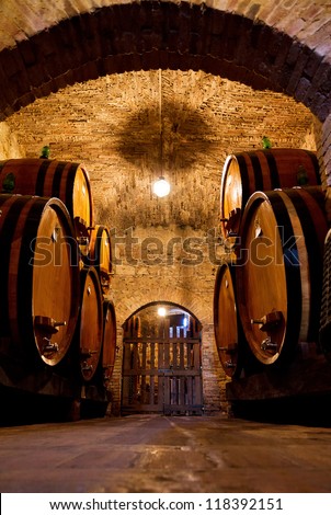 Old traditional dark wine cellar with big wooden barrels