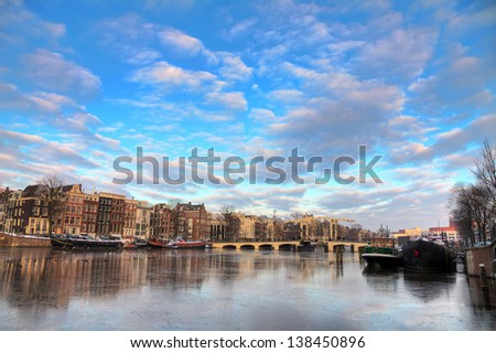 Beautiful winter panorama of the river Amstel and the skinny bridge in Amsterdam, the Netherlands. HDR