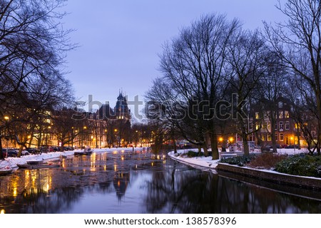 Beautiful twilight view in winter on the Stadhouderskade with the national state museum in the background in Amsterdam, the Netherlands
