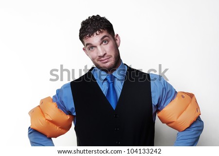 handsome business type man wearing rubber arm bands looking at the camera