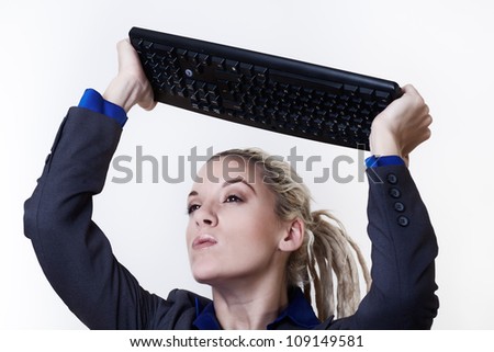 Business person with dreadlock hair getting mad at her keyboard at work