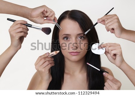 woman doing make up with many hands and arms helping her get the job done faster