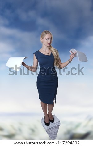 woman standing on a large pile of paper