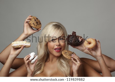 sexy woman surrounded  by many hands holding cream cakes with so much choice and temptation is she going to forget about her diet and indulge herself
