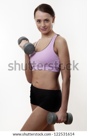 athletic young lady doing workout with weights using dumbbells ez