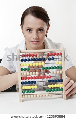 young attractive woman using a wooden abacus to count and add up her sums